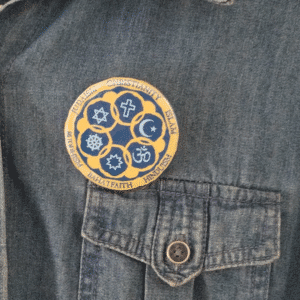 Circle of Religions Button on shirt