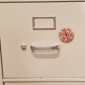 Circle of Religions magnet on cabinet