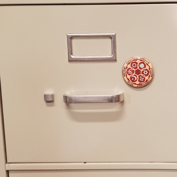 Circle of Religions magnet on cabinet