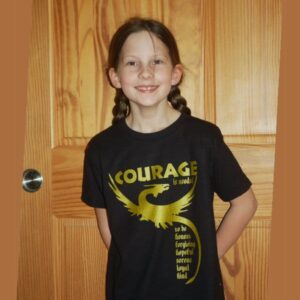 Child modeling the Courage is needed dragon T-shirt