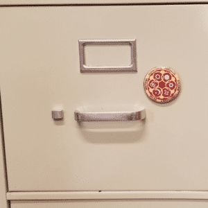Circle of Religions magnet on filing cabinet