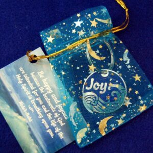 Sea of Joy medallion in cheerful moon and star organza pouch